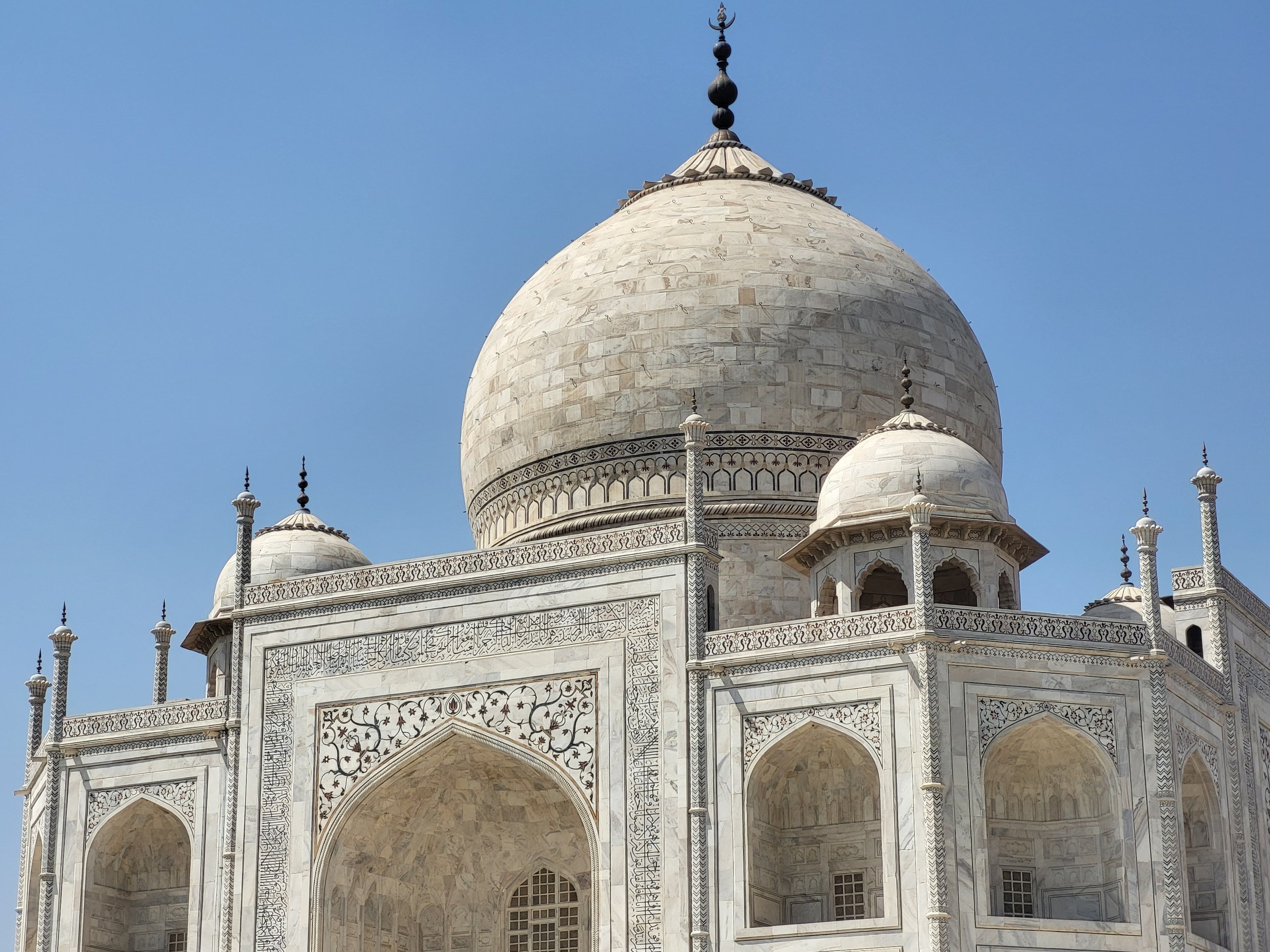 Close-up of pietra dura marble inlay work with semi-precious stone flowers on the Taj Mahal walls