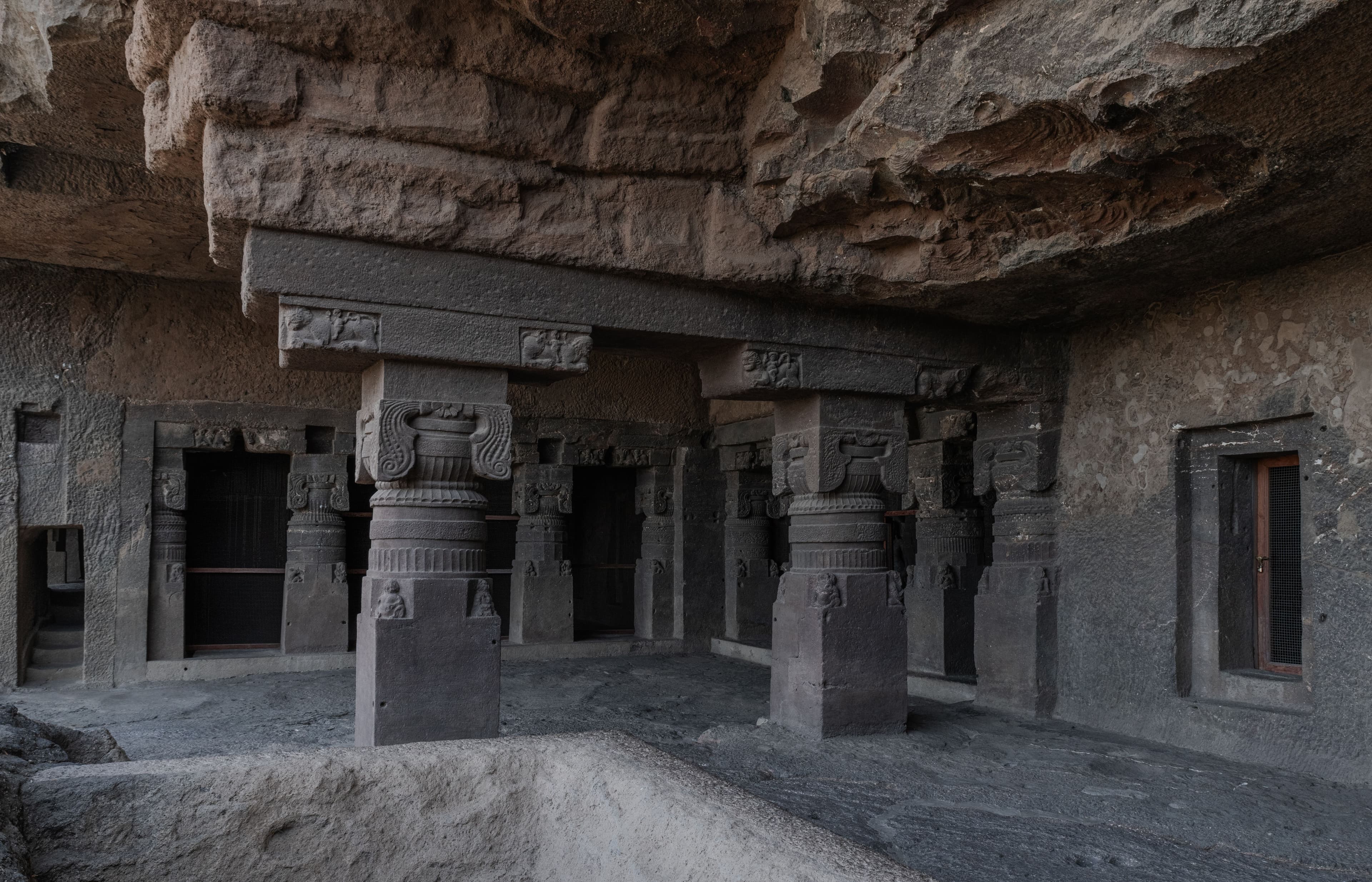 Ajanta Caves exterior carved into basalt cliff above Waghora River, Maharashtra India