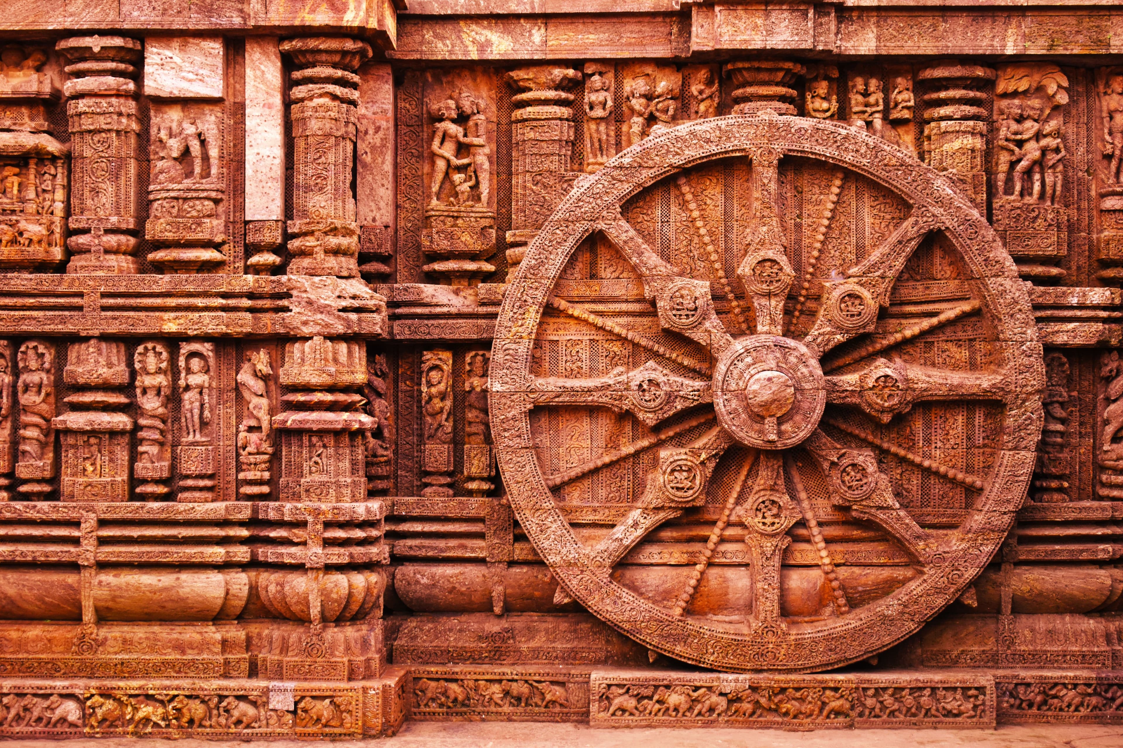 Detailed stone carving on Konark Sun Temple chariot wheel, 13th century Kalinga architecture