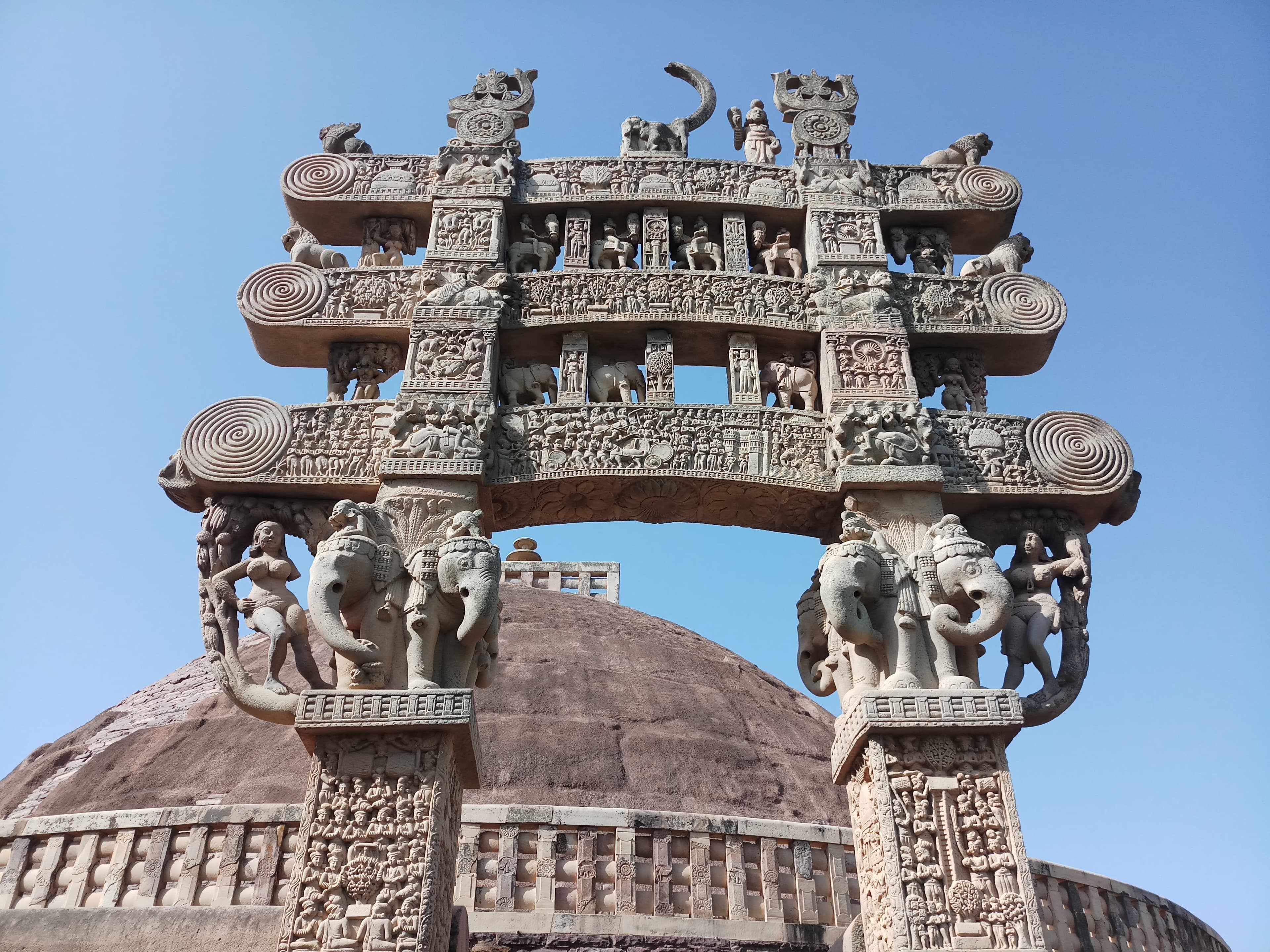 Detailed carved narrative panels on the North Torana gateway at Sanchi Stupa UNESCO World Heritage Site